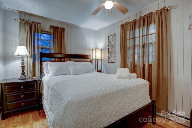 bedroom with ceiling fan and light hardwood / wood-style floors