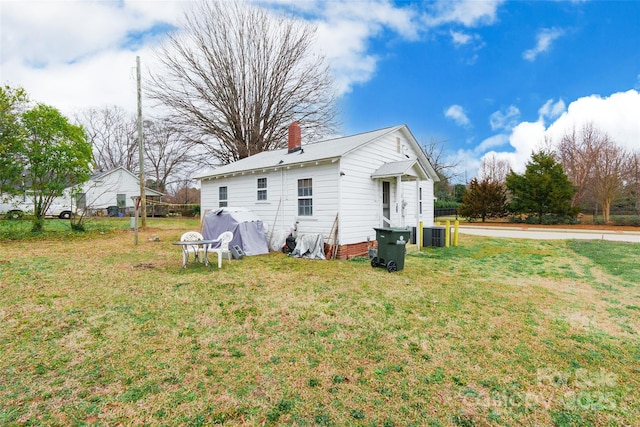 rear view of house featuring a yard