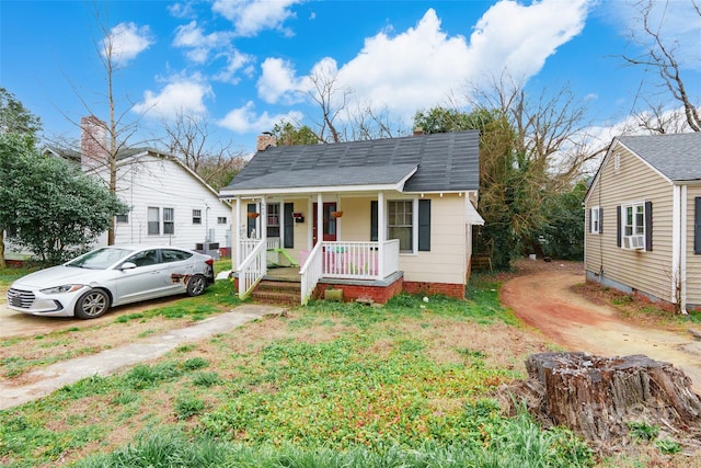 bungalow with cooling unit and covered porch