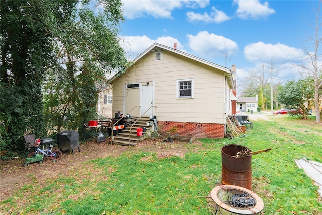 rear view of house with a yard