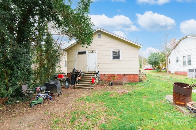 back of property featuring a lawn