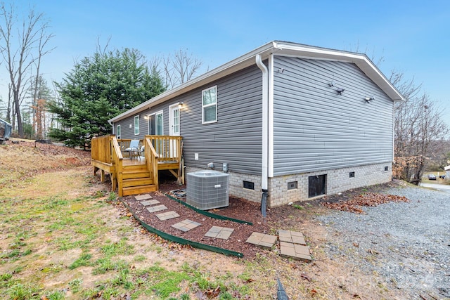 view of home's exterior with a deck and central air condition unit