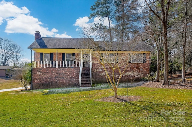 ranch-style house with a porch and a front yard