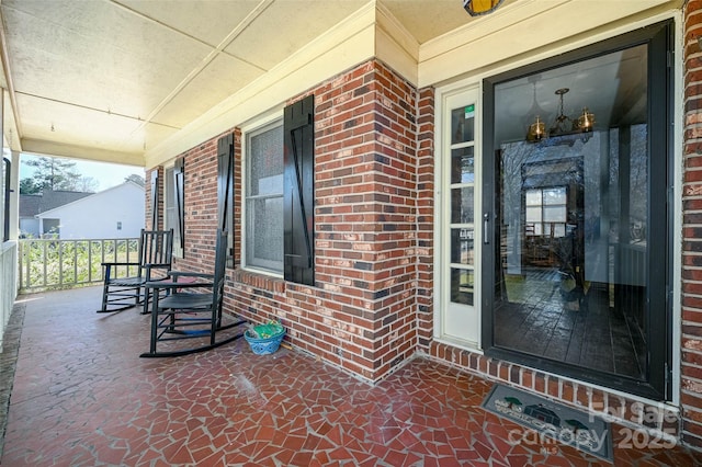 view of exterior entry featuring a porch