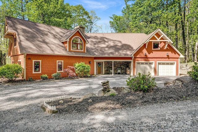 view of front of home with aphalt driveway, roof with shingles, and a chimney