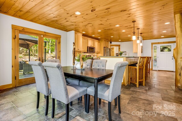 dining room featuring wooden ceiling, baseboards, recessed lighting, and stone tile floors