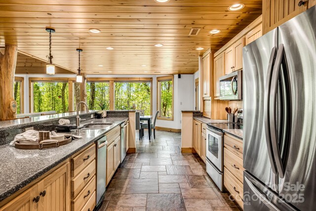 kitchen featuring stone tile flooring, recessed lighting, wooden ceiling, a sink, and appliances with stainless steel finishes