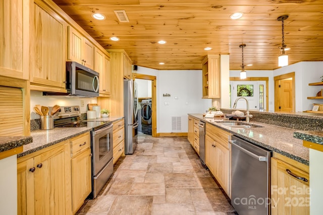 kitchen with baseboards, a sink, light brown cabinetry, and stainless steel appliances