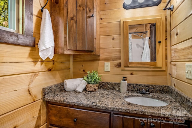 full bath featuring wooden walls, vanity, and a shower with curtain