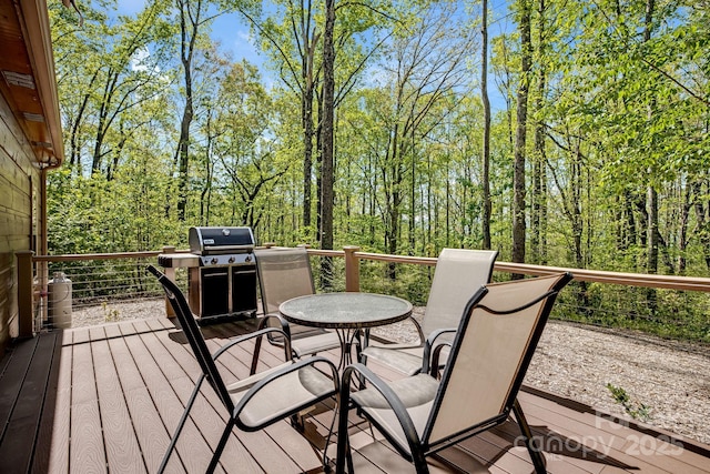 wooden deck with a grill