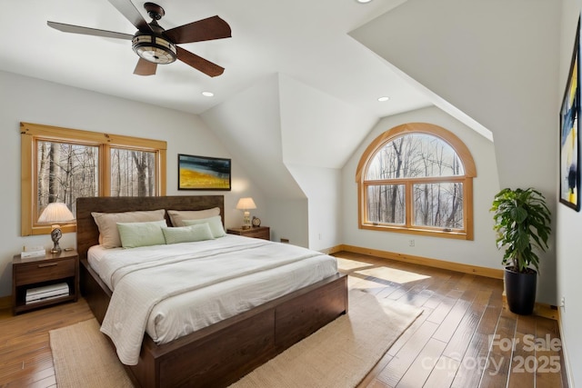 216 Log Gap Rd, Fairview, NC 28730 - bedroom with multiple windows, baseboards, hardwood / wood-style floors, lofted ceiling, and ceiling fan