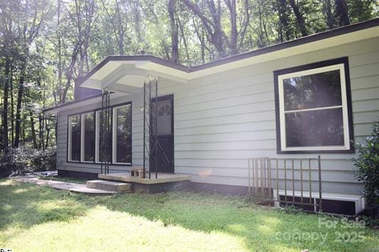 view of property exterior with a yard