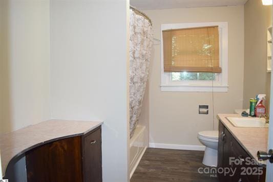 full bathroom featuring vanity, wood-type flooring, shower / bath combo, and toilet