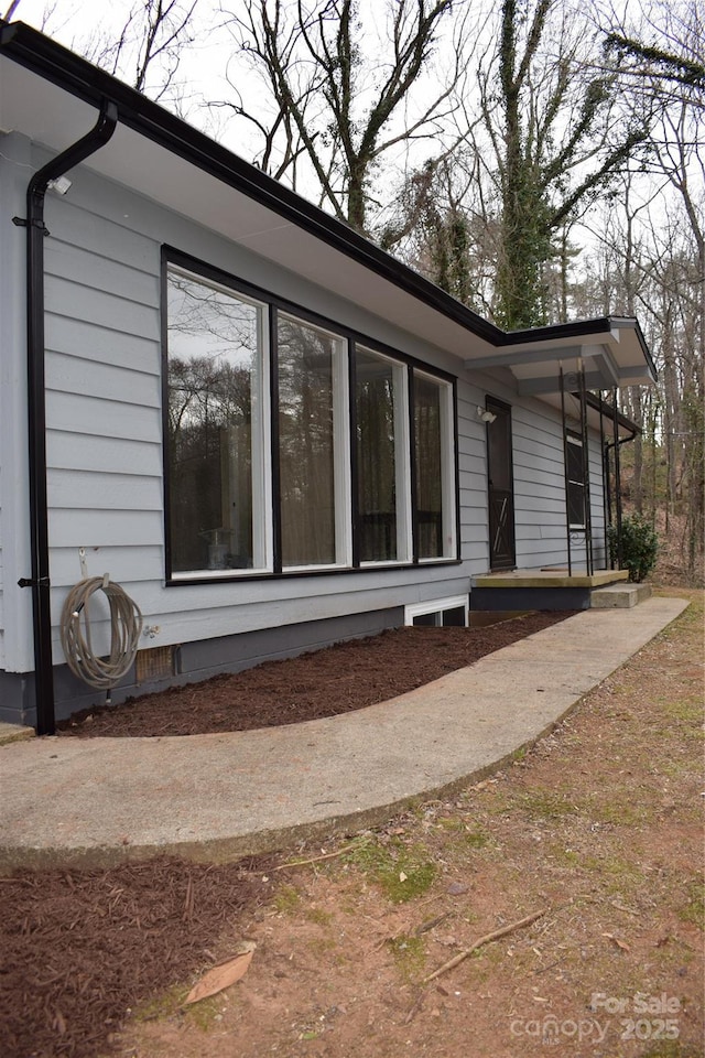 view of property exterior with crawl space