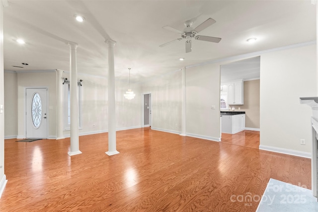 interior space with crown molding, ceiling fan, light hardwood / wood-style flooring, and ornate columns