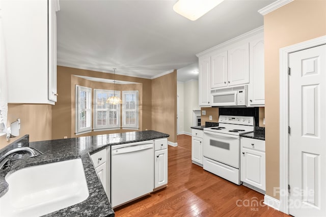 kitchen featuring white cabinetry, sink, white appliances, and light hardwood / wood-style floors