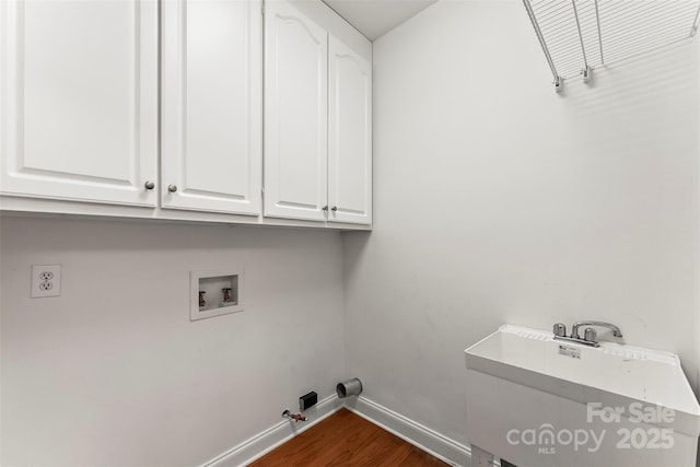 laundry room with hookup for a washing machine, gas dryer hookup, dark hardwood / wood-style flooring, and cabinets