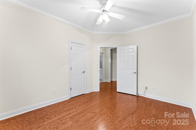 unfurnished room with hardwood / wood-style flooring, ceiling fan, and crown molding