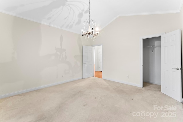 unfurnished bedroom with lofted ceiling, ornamental molding, a closet, a notable chandelier, and light colored carpet