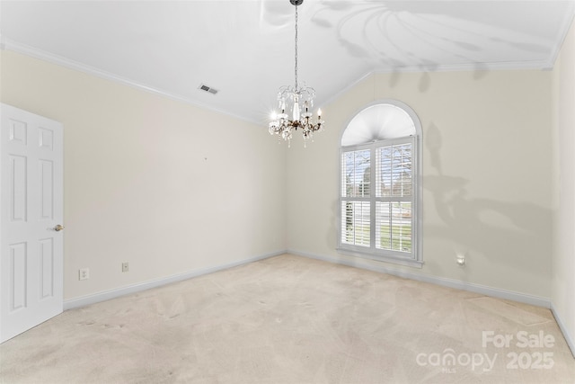 carpeted empty room with a notable chandelier, crown molding, and vaulted ceiling