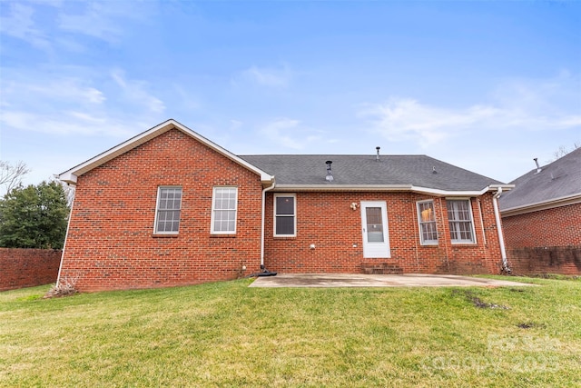 back of property with a yard and a patio area