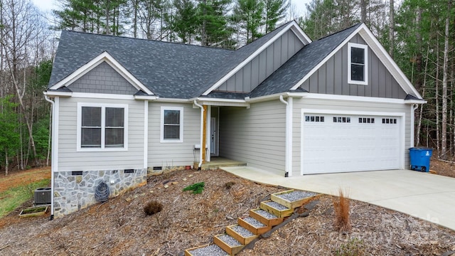 view of front of house with a garage and central AC