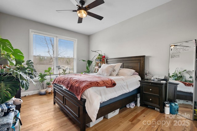 bedroom with ceiling fan and light wood-type flooring