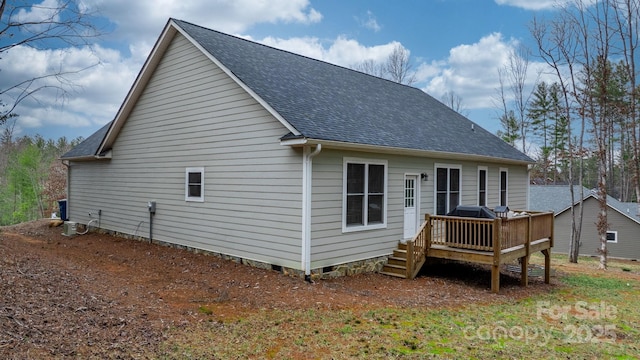 rear view of property featuring a wooden deck