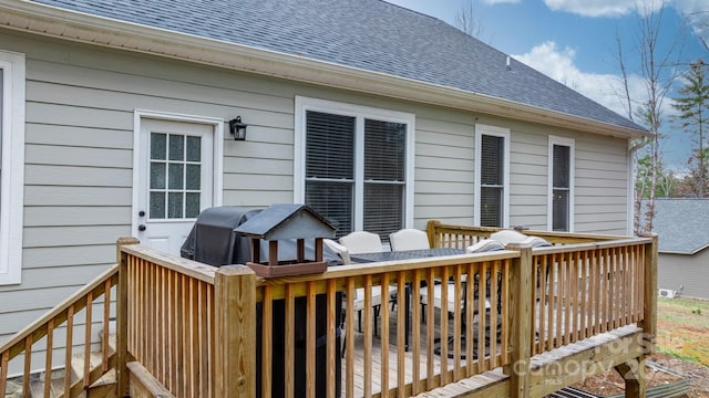 wooden terrace featuring a grill