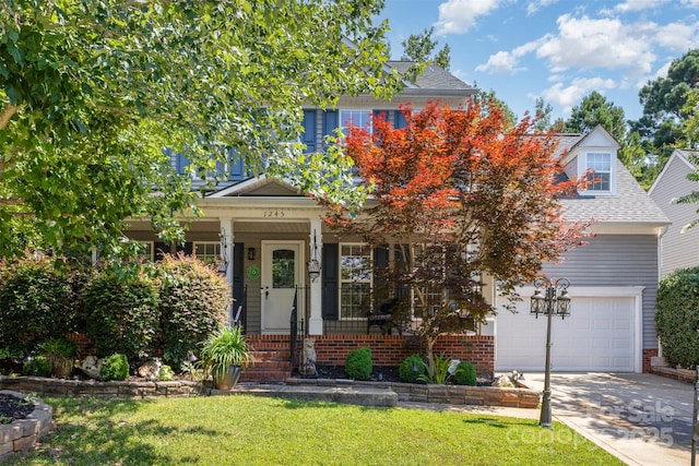 1245 Periwinkle Dr, Waxhaw, NC 28173 - view of property hidden behind natural elements featuring driveway, a front lawn, an attached garage, covered porch, and brick siding