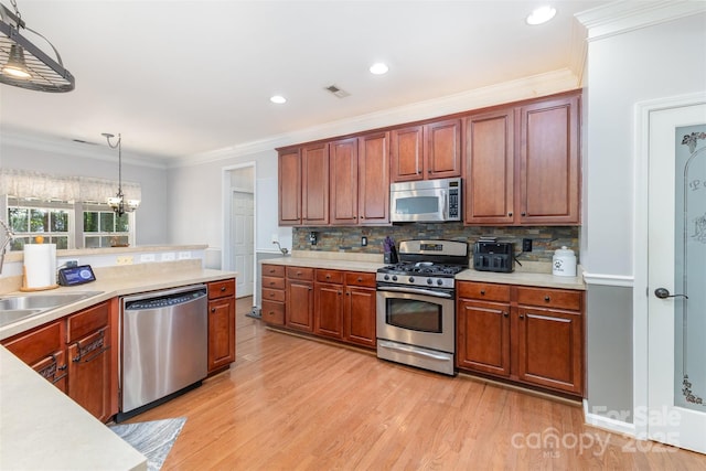 1245 Periwinkle Dr, Waxhaw, NC 28173 - kitchen with appliances with stainless steel finishes, light countertops, light wood-type flooring, decorative light fixtures, and tasteful backsplash