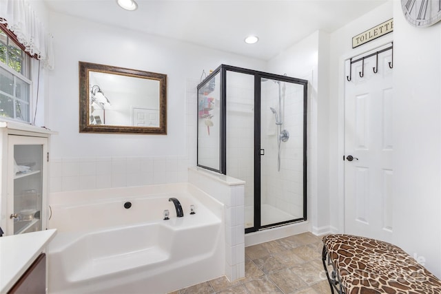 1245 Periwinkle Dr, Waxhaw, NC 28173 - bathroom with a garden tub, a shower stall, vanity, and recessed lighting