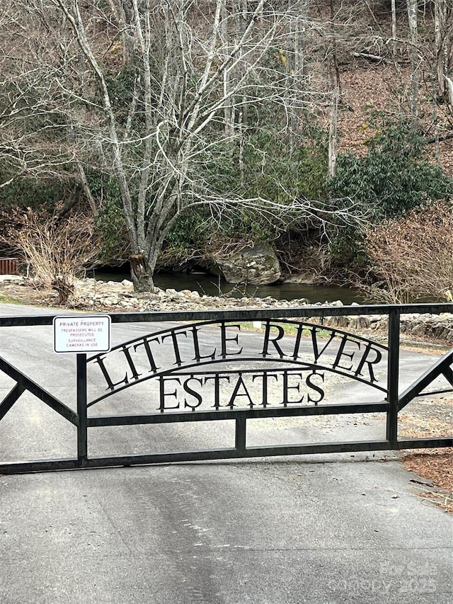 view of gate with a water view