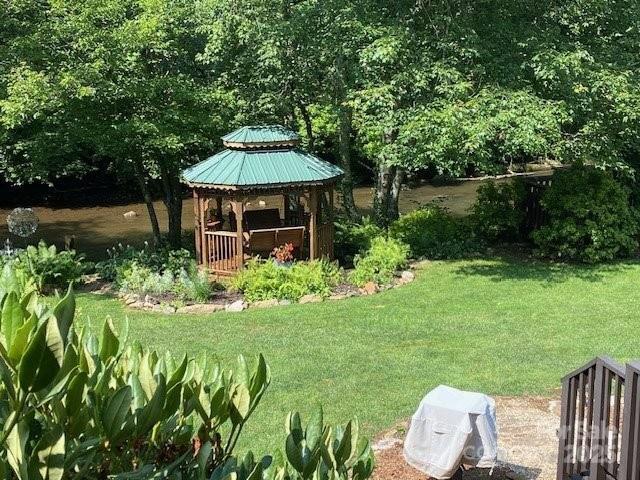 view of yard featuring a gazebo and a water view