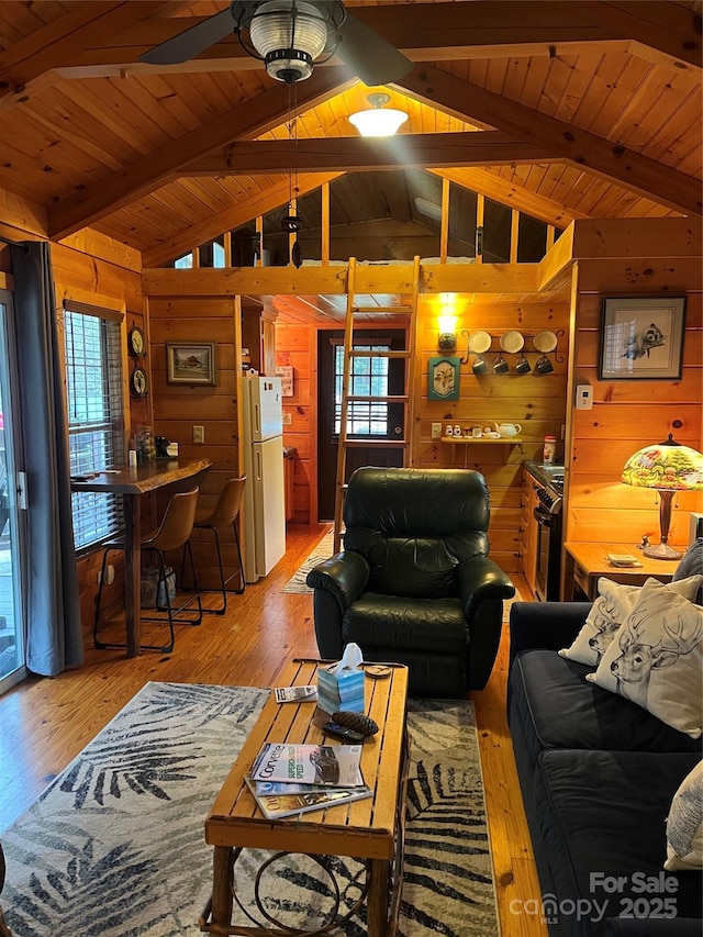 living room featuring hardwood / wood-style flooring, plenty of natural light, and wood walls