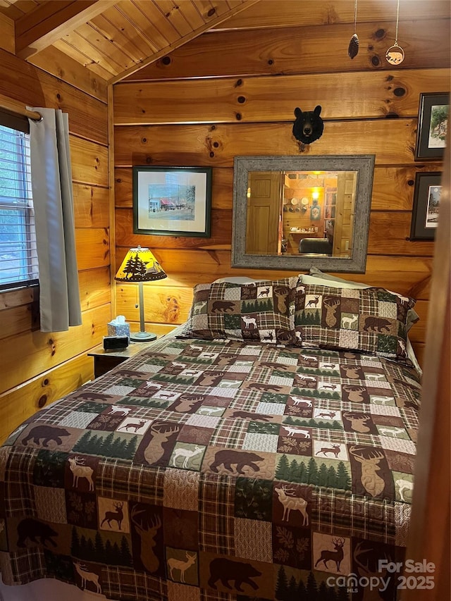 bedroom with vaulted ceiling, wooden ceiling, and wooden walls