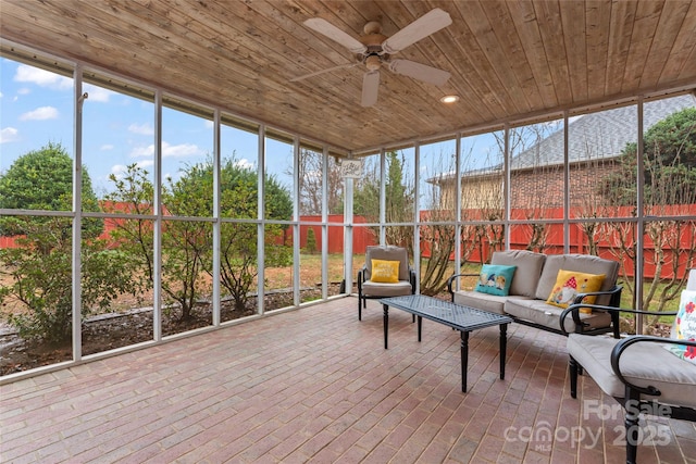 sunroom / solarium featuring wooden ceiling and ceiling fan