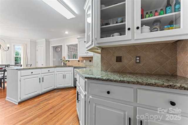 kitchen with sink, dark stone counters, and white cabinets