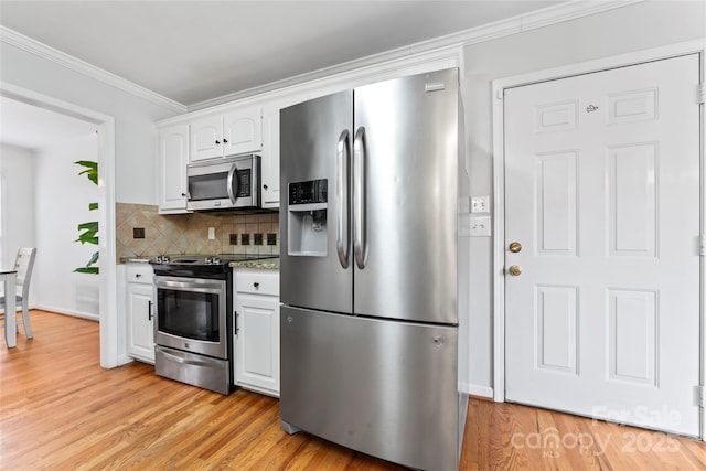 kitchen featuring white cabinetry, backsplash, ornamental molding, light hardwood / wood-style floors, and stainless steel appliances