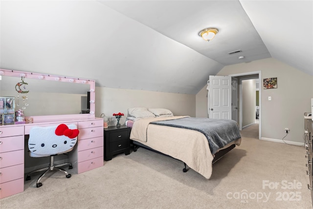 carpeted bedroom with lofted ceiling