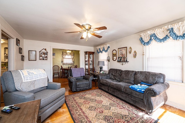 living room featuring hardwood / wood-style flooring and ceiling fan