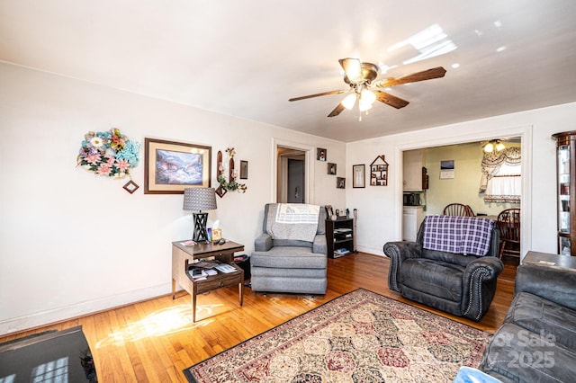 living room with hardwood / wood-style flooring and ceiling fan