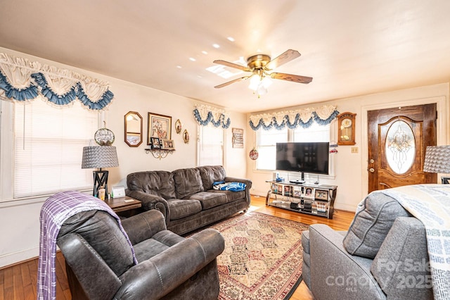 living room featuring hardwood / wood-style floors and ceiling fan