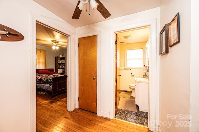 corridor featuring sink and light hardwood / wood-style floors