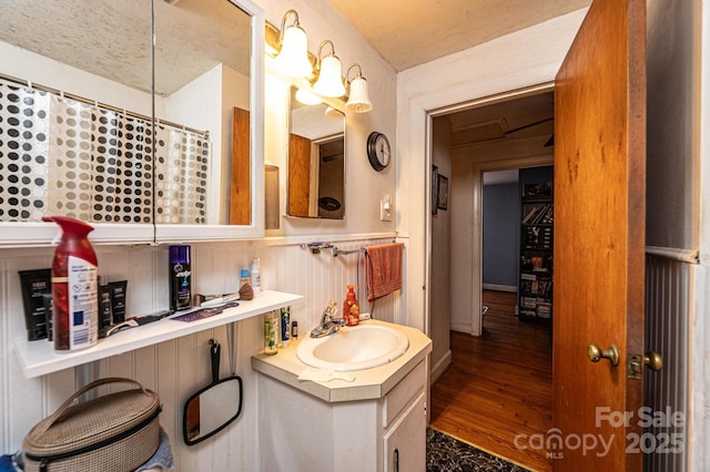 bathroom with vanity, wood-type flooring, and curtained shower