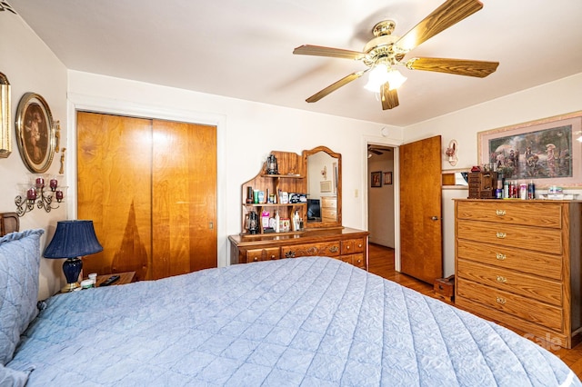 bedroom featuring wood-type flooring, ceiling fan, and a closet