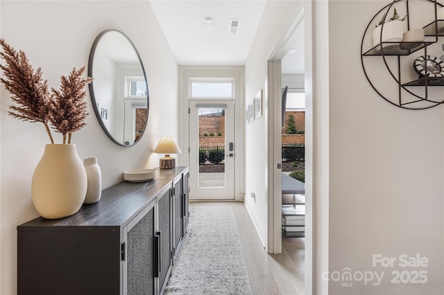 corridor featuring light hardwood / wood-style floors