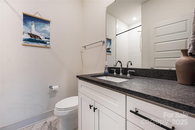 bathroom featuring vanity, a shower, and toilet