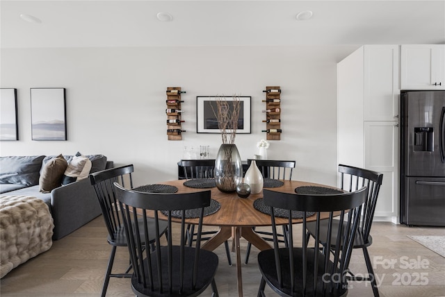 dining space with light hardwood / wood-style floors