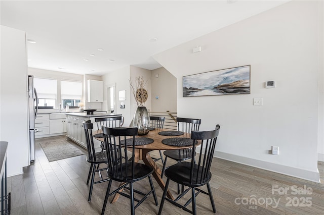 dining area featuring dark wood-type flooring